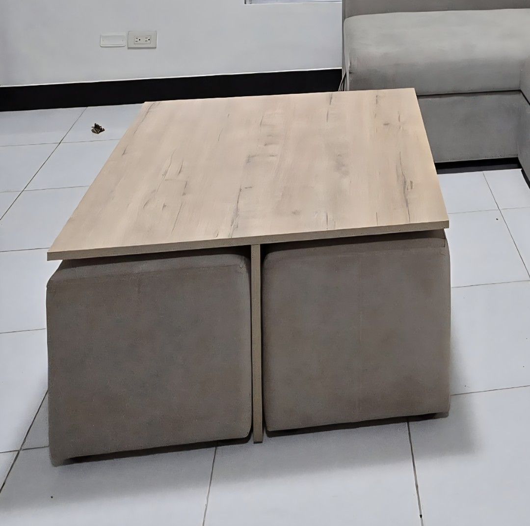 Coffee Table with Ottoman Set (Category: Tables & Sets) located in Manila. Submitted by knasun15 (Listing ID 1438615829, Image 1). Description: - Stylish coffee table with light wood-grain finish - Includes four matching ottomans - Ottomans conveniently store under the table - Neutral color complements any decor - Ideal for small spaces - Provides extra seating.