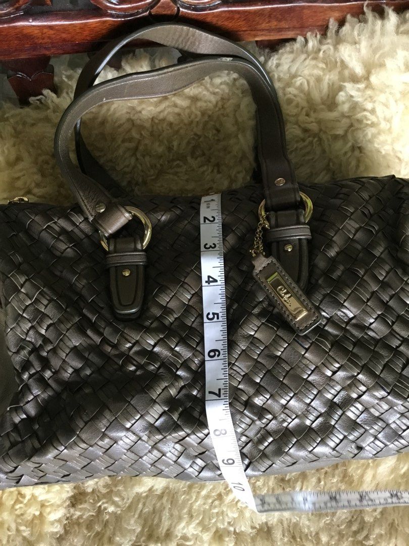Cole Haan Woven Leather Handbag (Category: Luxury Bags & Wallets) located in Las Pinas. Submitted by starlacollection (Listing ID 1438688169, Image 3). Description: - Cole Haan handbag - Woven leather design - Zip closure - Double handles - Spacious interior with zippered pocket - Dimensions: Approximately 11" (L) x 7" (H) - Neutral color.