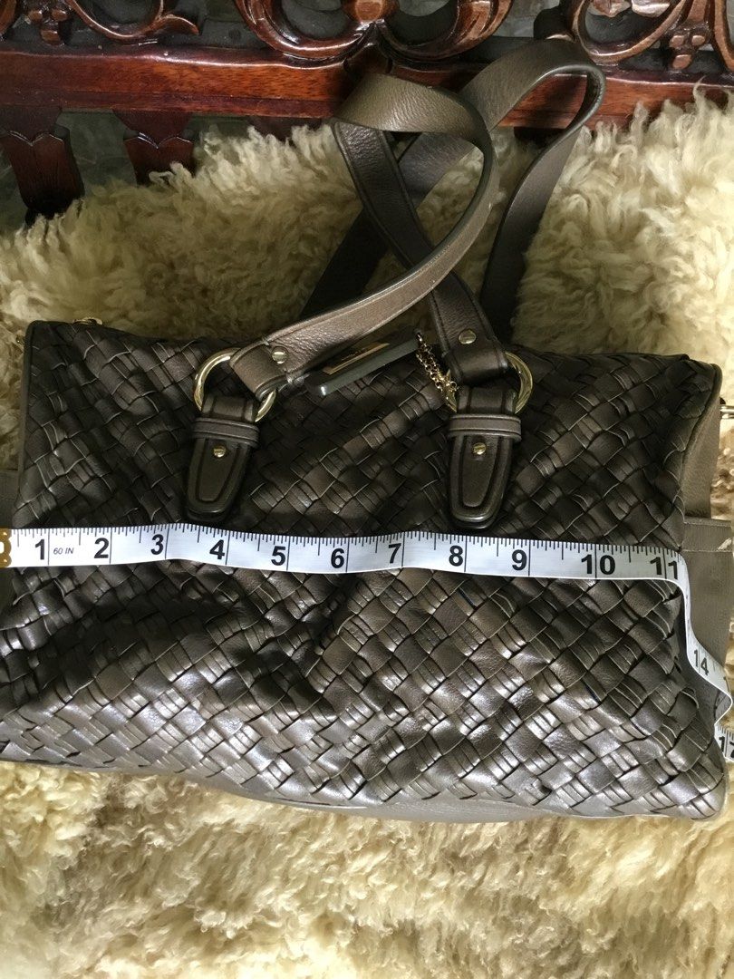 Cole Haan Woven Leather Handbag (Category: Luxury Bags & Wallets) located in Las Pinas. Submitted by starlacollection (Listing ID 1438688169, Image 2). Description: - Cole Haan handbag - Woven leather design - Zip closure - Double handles - Spacious interior with zippered pocket - Dimensions: Approximately 11" (L) x 7" (H) - Neutral color.