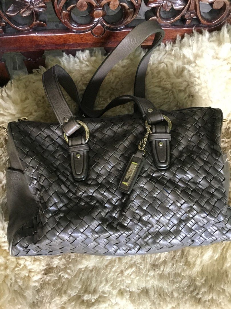 Cole Haan Woven Leather Handbag (Category: Luxury Bags & Wallets) located in Las Pinas. Submitted by starlacollection (Listing ID 1438688169, Image 1). Description: - Cole Haan handbag - Woven leather design - Zip closure - Double handles - Spacious interior with zippered pocket - Dimensions: Approximately 11" (L) x 7" (H) - Neutral color.