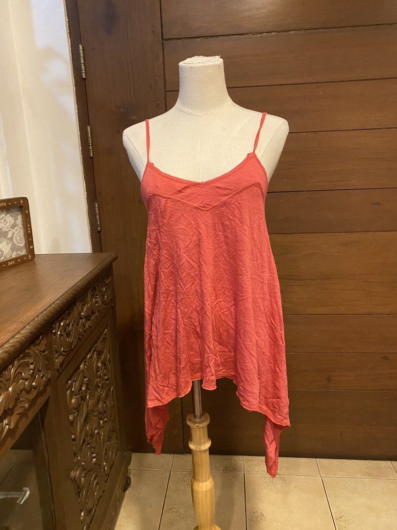 Coral Asymmetrical Halter Tank Top (Category: Sleeveless) located in Manila. Submitted by bels.finds (Listing ID 1438662970, Image 2). Description: - Coral-colored halter tank top - Size: S-L - Asymmetrical, flowing hemline .