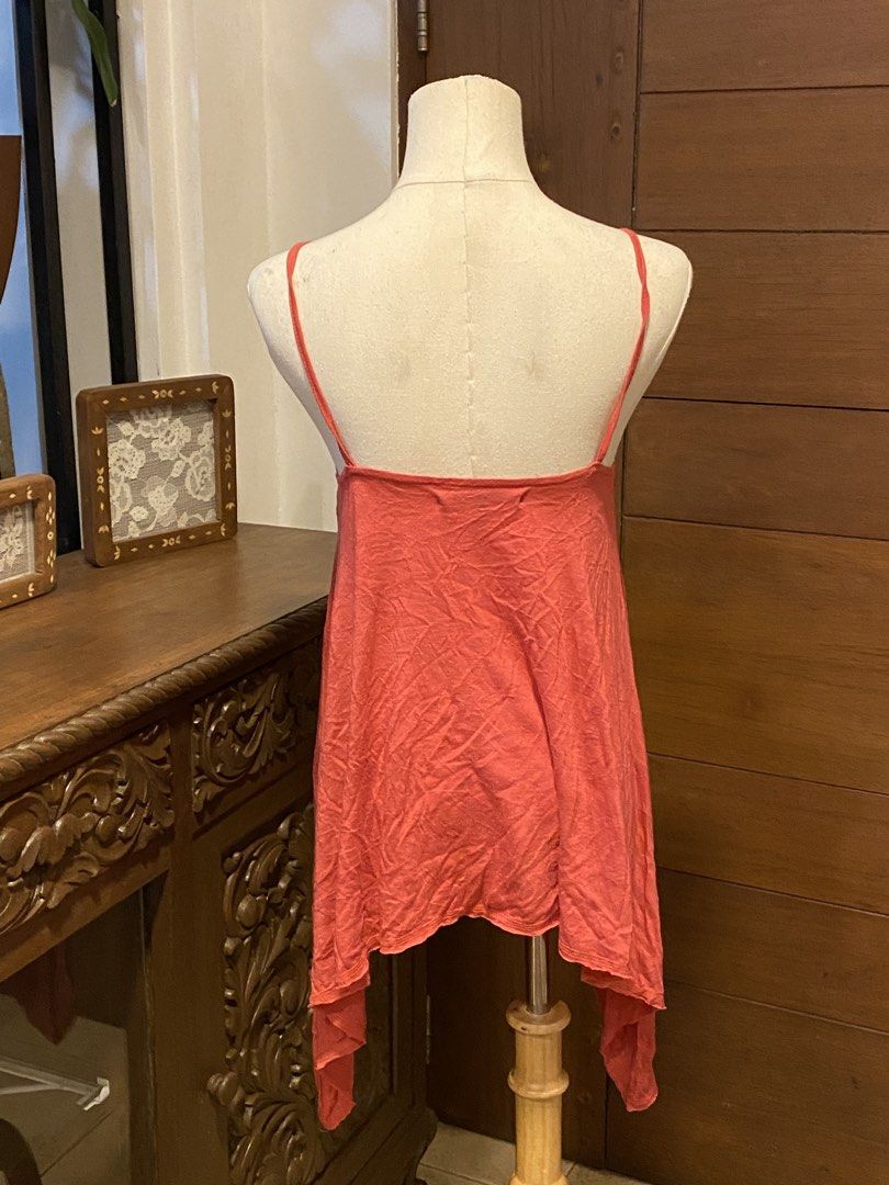 Coral Asymmetrical Halter Tank Top (Category: Sleeveless) located in Manila. Submitted by bels.finds (Listing ID 1438662970, Image 3). Description: - Coral-colored halter tank top - Size: S-L - Asymmetrical, flowing hemline .