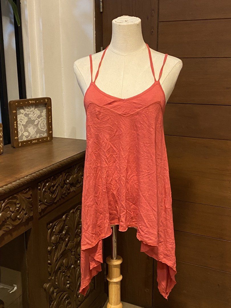 Coral Asymmetrical Halter Tank Top (Category: Sleeveless) located in Manila. Submitted by bels.finds (Listing ID 1438662970, Image 1). Description: - Coral-colored halter tank top - Size: S-L - Asymmetrical, flowing hemline .