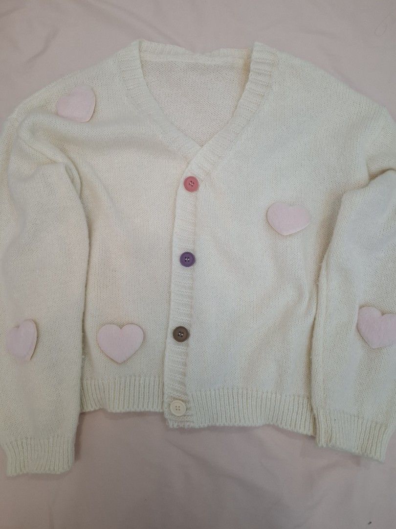 Cream Cardigan with Hearts (Category: Coats, Jackets and Outerwear) located in Muntinlupa City. Submitted by coolclosetcleaner (Listing ID 1438685410, Image 1). Description: - Cream-colored cardigan - PRICE IS NEGOTIABLE - 3d Hearts - V-neckline - Button closure - Long sleeves with ribbed cuffs - Unique, colorful buttons - Made from soft, cozy fabric.