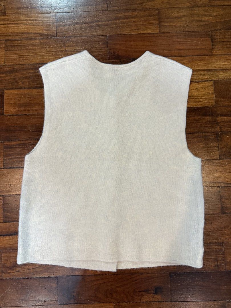 Cream-colored Sleeveless Knitted Vest with Buttons (Category: Sleeveless) located in Quezon City. Submitted by daphnelarissa (Listing ID 1438637021, Image 2). Description: - Cream-colored sleeveless vest - Round neckline - Button-down closure with decorative buttons - Simple, clean design - Suitable for layering - Soft material - Plain back Can fit until large body frames.