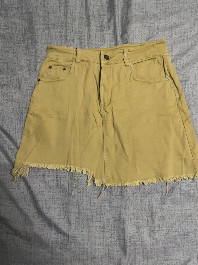 Denim Skirt (Category: Skirts) located in Quezon City. Submitted by listless32 (Listing ID 1438690347, Image 1). Description: Waist 27 length 15denim skirt with classic design, front and back pockets, frayed hem, and button/zipper closure. Versatile for various outfits..