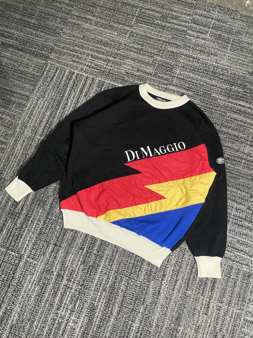 Di Maggio Colorblock Sweatshirt (Category: Coats, Jackets and Outerwear) located in Manila. Submitted by rdtp2 (Listing ID 1438611197, Image 2). Description: - Size XL - Dimes: 22x25 - Di Maggio sweatshirt - Unique colorblock design - Black body - White collar and cuffs - Colorblock sections: red, yellow, and blue - Brand logo on front - Small logo patch on sleeve.
