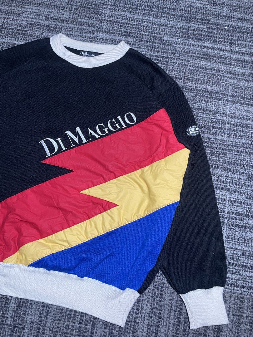 Di Maggio Colorblock Sweatshirt (Category: Coats, Jackets and Outerwear) located in Manila. Submitted by rdtp2 (Listing ID 1438611197, Image 3). Description: - Size XL - Dimes: 22x25 - Di Maggio sweatshirt - Unique colorblock design - Black body - White collar and cuffs - Colorblock sections: red, yellow, and blue - Brand logo on front - Small logo patch on sleeve.