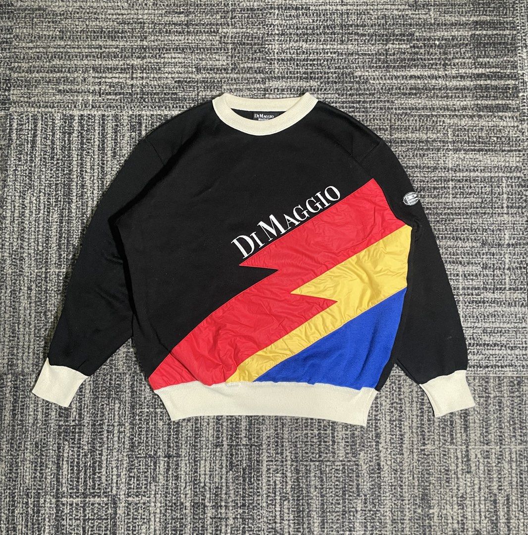 Di Maggio Colorblock Sweatshirt (Category: Coats, Jackets and Outerwear) located in Manila. Submitted by rdtp2 (Listing ID 1438611197, Image 1). Description: - Size XL - Dimes: 22x25 - Di Maggio sweatshirt - Unique colorblock design - Black body - White collar and cuffs - Colorblock sections: red, yellow, and blue - Brand logo on front - Small logo patch on sleeve.