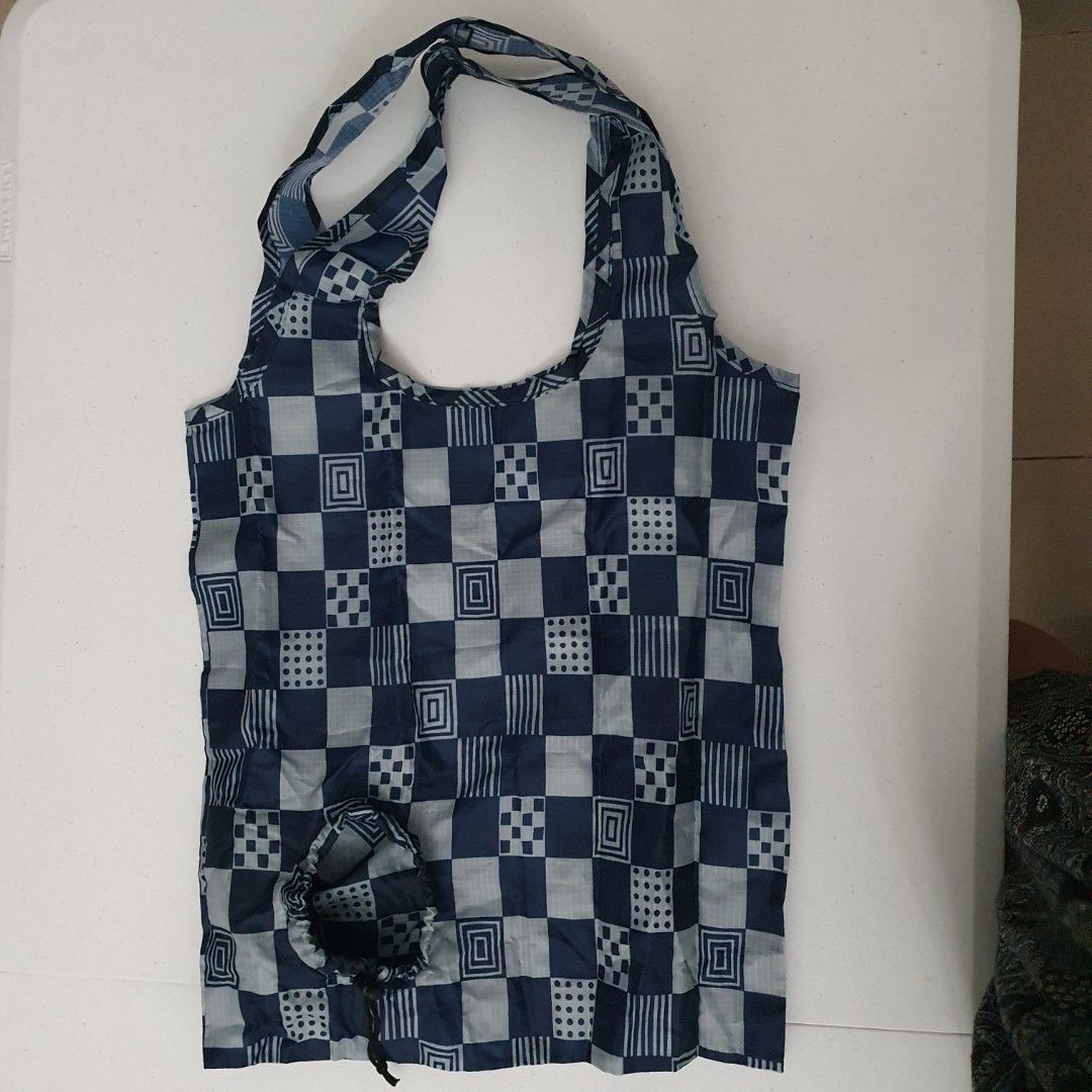Foldable Shopping Bag - Checkered Pattern market bag eco bag (Category: Tote Bags) located in Paranaque City. Submitted by cobien (Listing ID 1438690372, Image 2). Description: - Stylish navy blue and gray checkered pattern - Foldable design for easy storage - Features two handles for comfortable carrying - Made of lightweight material (likely nylon) - Ideal for groceries, shopping, and eco-friendly use.