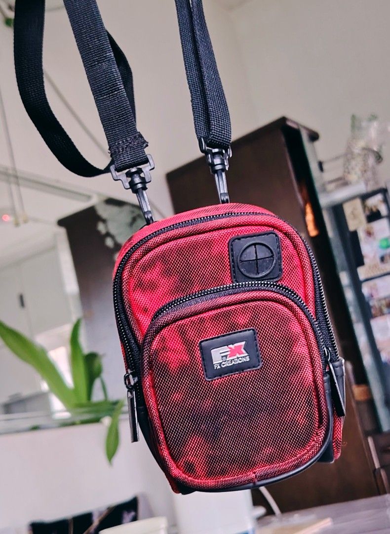 FX Creations Crossbody Bag (Category: Cross-body Bags) located in Bulacan. Submitted by shell_23 (Listing ID 1438579689, Image 1). Description: - FX Creations crossbody bag - Red and black color scheme - Multiple compartments for organization - Adjustable black strap - Zippered front pocket - Main compartment with interior pockets - Velcro strap at the back fit for camera free shipping .