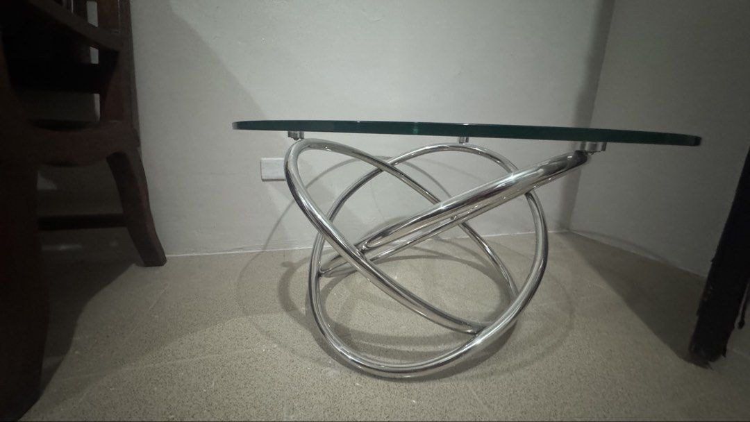 Glass Top Coffee Table - 24” (Category: Tables & Sets) located in Manila. Submitted by _anjdecluttermnl21 (Listing ID 1438554580, Image 2). Description: - Modern coffee table - Clear glass top - Unique intertwined metal base - Stylish design - Ideal for living rooms and lounges - Functional surface for drinks, books, or decor - Sleek glass top - Elegant metal base.