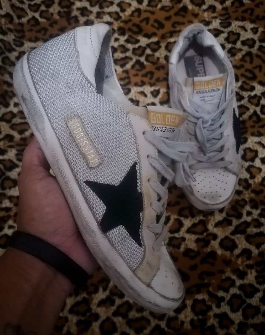 Golden Goose Superstar Sneakers (Category: Sneakers) located in Cebu City. Submitted by roadthrift (Listing ID 1438541537, Image 2). Description: - Golden Goose Superstar sneakers - White with black star - Size 37 - Made in Italy - Genuine leather insoles - Mesh detailing and leather accents - Signs of wear on soles and uppers.