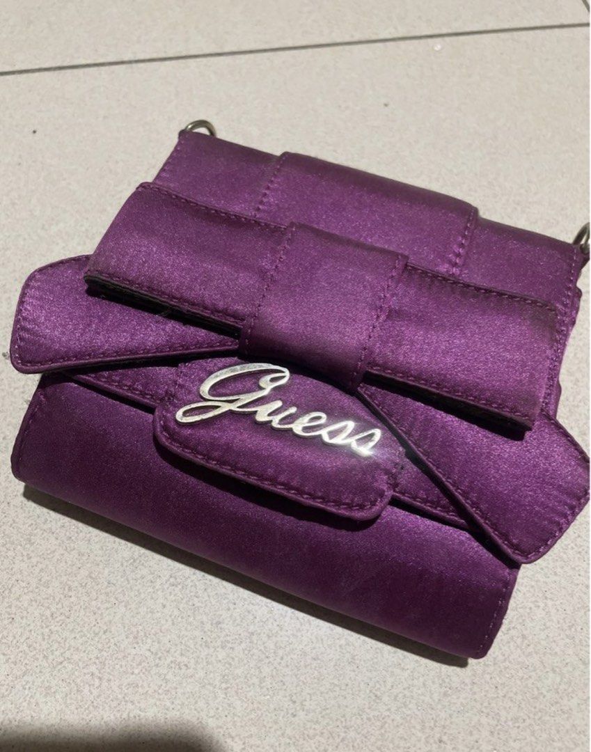 Guess Purple Satin Handbag (Category: Luxury Bags & Wallets) located in Manila. Submitted by sapsari (Listing ID 1438630288, Image 1). Description: Purple satin crossbody bag from Guess. - used once. -Includes a bag strap. -Has a small pocket inside. - minimal flaw: see last two pics, black dots inside. .