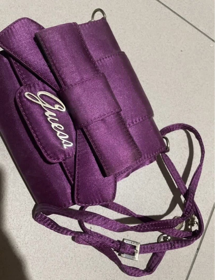 Guess Purple Satin Handbag (Category: Luxury Bags & Wallets) located in Manila. Submitted by sapsari (Listing ID 1438630288, Image 2). Description: Purple satin crossbody bag from Guess. - used once. -Includes a bag strap. -Has a small pocket inside. - minimal flaw: see last two pics, black dots inside. .
