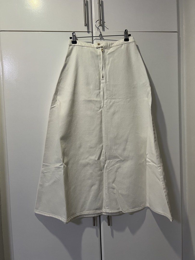 H&M Denim Midi Skirt - White (Category: Skirts) located in Makati City. Submitted by jcc999 (Listing ID 1438573790, Image 1). Description: - H&M white denim midi skirt - Size: XS - Condition: New with tags and packaging - Features: Zipper closure, classic design - Material: Denim - Style: Versatile, suitable for casual and semi-formal wear.