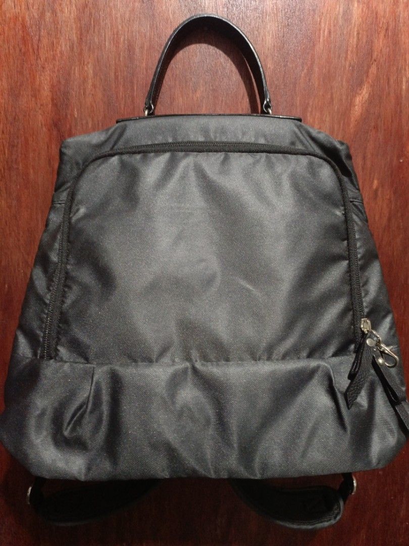 Kanana Project Backpack (Category: Backpacks) located in San Jose del Monte. Submitted by m_nshop (Listing ID 1438655690, Image 1). Description: - Kanana Project backpack - Top handle and adjustable straps - Multiple interior compartments and pocke - Purple interior lining - Secure zipper closure - Silver Kanana Project logo - Adjustable back straps - Durable nylon material payment first jnt. or lalamove courier.