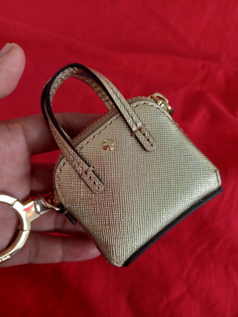 Kate Spade Gold Handbag Key Chain (Category: Luxury Bags & Wallets) located in Tuguegarao City. Submitted by zenphoenix-7ad615 (Listing ID 1438565041, Image 1). Description: - Kate Spade keychain - Mini handbag design - Gold color - Top handle - Zipper closure - Gold-tone ring - Kate Spade logo.