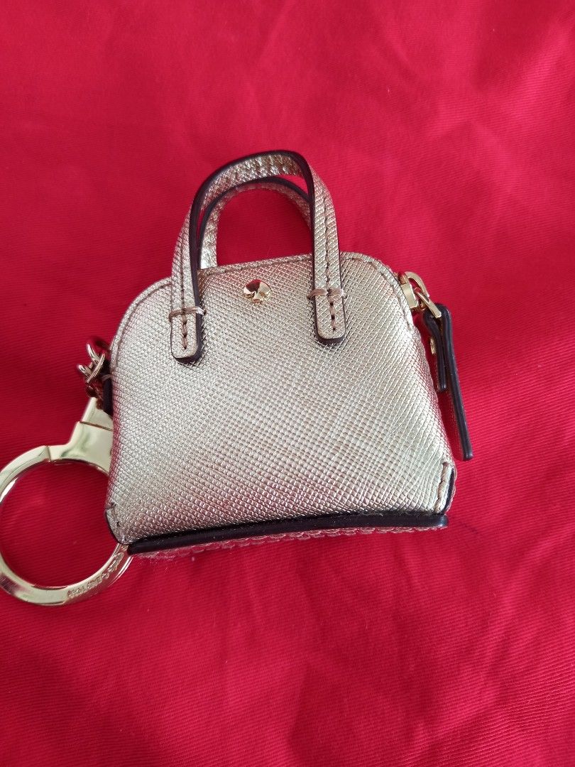 Kate Spade Gold Handbag Key Chain (Category: Luxury Bags & Wallets) located in Tuguegarao City. Submitted by zenphoenix-7ad615 (Listing ID 1438565041, Image 3). Description: - Kate Spade keychain - Mini handbag design - Gold color - Top handle - Zipper closure - Gold-tone ring - Kate Spade logo.