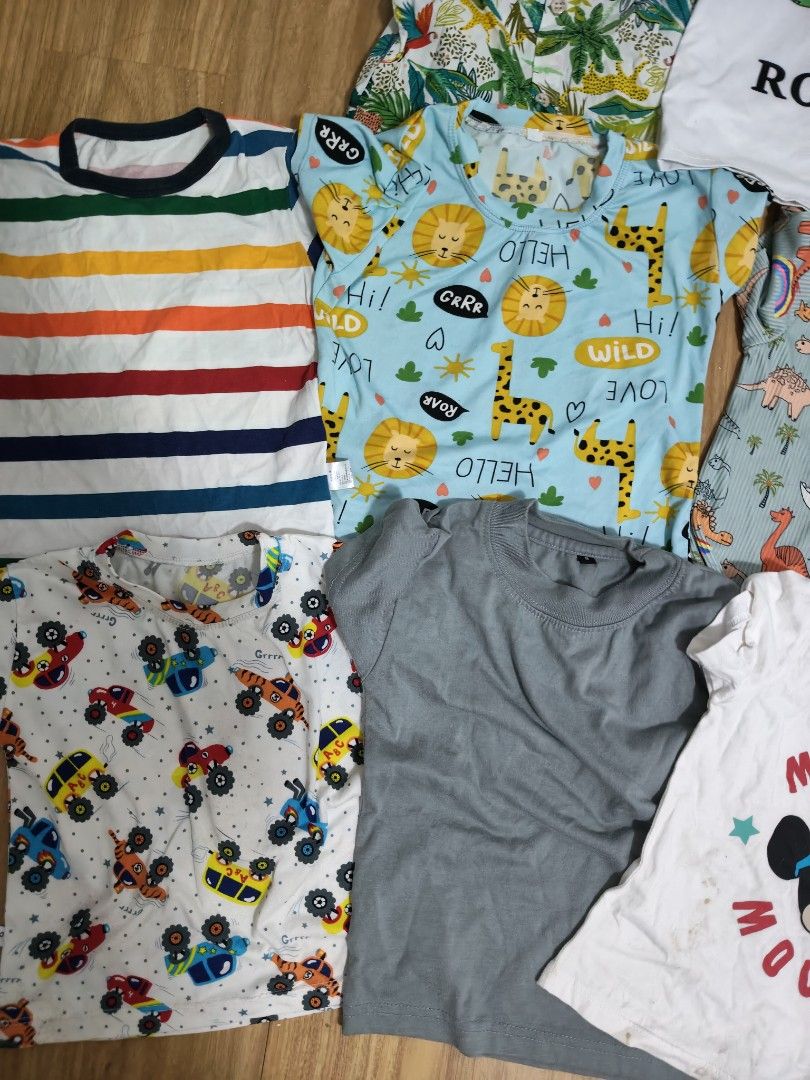 Kids' T-shirts and Shorts Bundle (Category: Babies & Kids Fashion) located in Mandaluyong City. Submitted by derekalava (Listing ID 1438560724, Image 2). Description: Bundle of kids' clothing including various t-shirts and shorts. Features a Mickey Mouse shirt, a shirt with the name "Rocho", and shirts with animal and vehicle prints. Includes denim shorts, red shorts, and patterned shorts. Perfect for everyday wear. if interested please call txt 