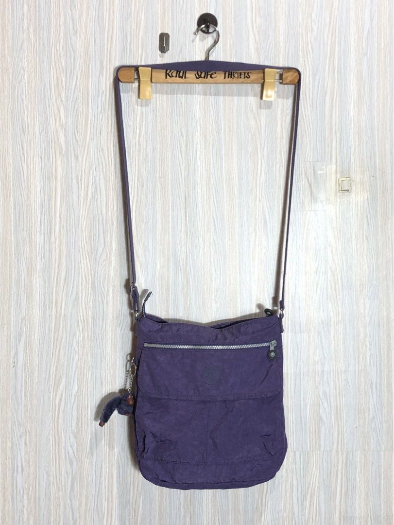 Kipling Purple Shoulder Bag K15063-661 (Category: Shoulder Bags) located in Montevista. Submitted by rdthriftshub (Listing ID 1438691240, Image 2). Description: - Authentic Kipling shoulder bag - Vibrant purple color - Zip closure - Adjustable strap - Includes signature Kipling monkey charm - Model number: K15063-661 - Made in China - Features front flap pocket and main compartment - Ideal for everyday use.