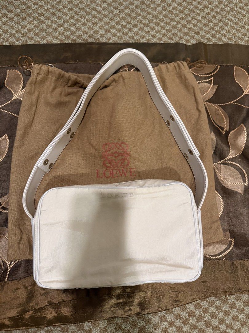 Loewe Shoulder Bag (Category: Luxury Bags & Wallets) located in Mandaluyong City. Submitted by travelisimo87 (Listing ID 1438552534, Image 3). Description: - Loewe shoulder bag - Neutral color - Rectangular shape - Top zipper closure - Includes shoulder strap and dust bag - Loewe logo detail - Black interior lining - Made in Spain.