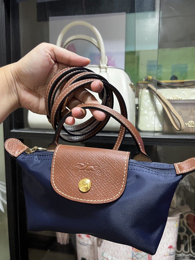 Longchamp Le Pliage Top Handle Bag (Category: Luxury Bags & Wallets) located in Caloocan City. Submitted by ericavi_g (Listing ID 1438613377, Image 3). Description: - Longchamp Le Pliage Top Handle Bag - Available Colors: Gray, Black, Navy Blue - Features: - Top Handle - Detachable Shoulder Strap - Flap Closure - Snap Closure with Longchamp Logo.
