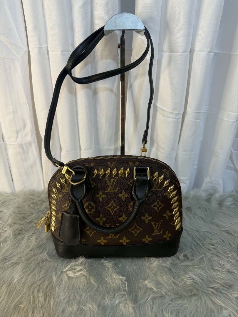 Louis Vuitton Alma BB Studded Handbag (Category: Luxury Bags & Wallets) located in Manila. Submitted by solisraque20674 (Listing ID 1438657217, Image 3). Description: - Authentic Louis Vuitton Alma BB - Iconic Monogram canvas - Black leather accents - Gold-tone hardware - Top handle & detachable shoulder strap - Secure zip closure with padlock detail - Classic and stylish design.