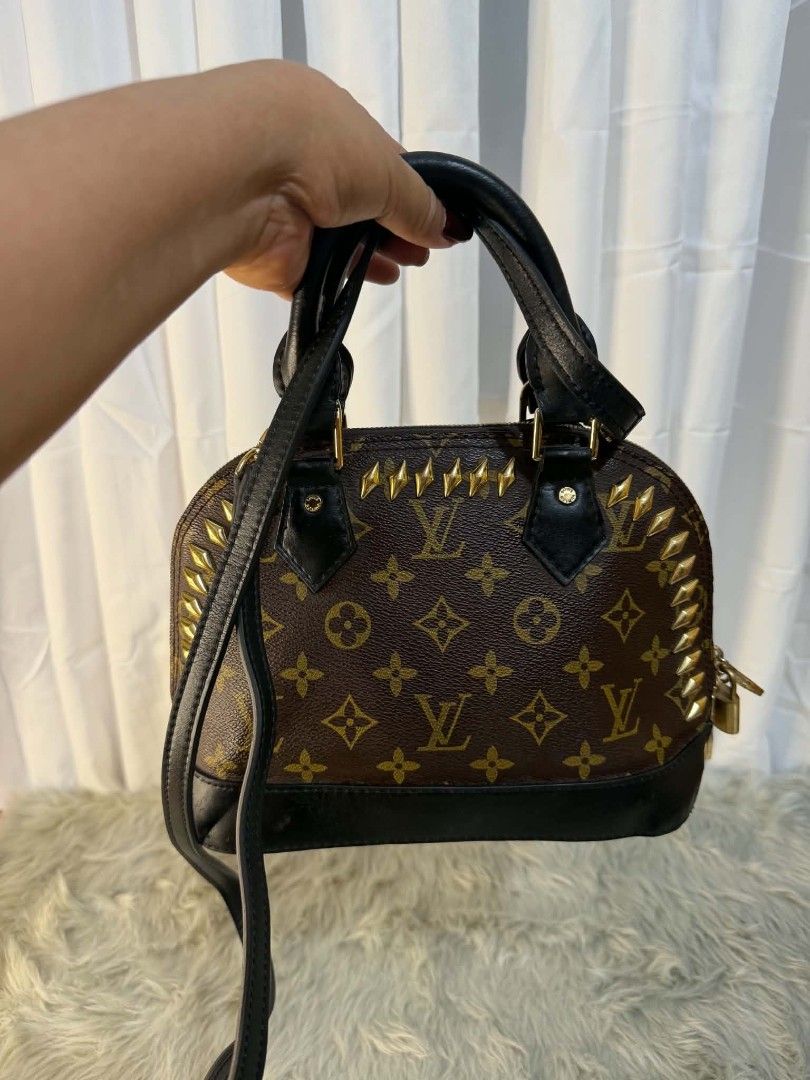 Louis Vuitton Alma BB Studded Handbag (Category: Luxury Bags & Wallets) located in Manila. Submitted by solisraque20674 (Listing ID 1438657217, Image 1). Description: - Authentic Louis Vuitton Alma BB - Iconic Monogram canvas - Black leather accents - Gold-tone hardware - Top handle & detachable shoulder strap - Secure zip closure with padlock detail - Classic and stylish design.