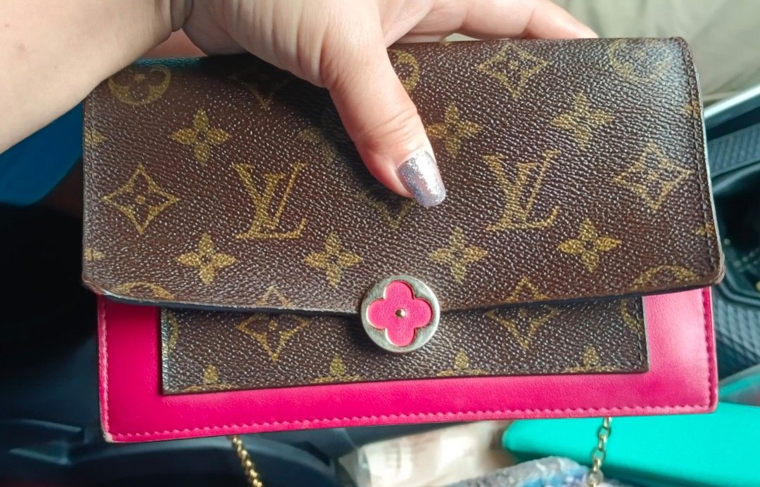 Louis Vuitton Monogram Flore Chain Burgundy (Category: Luxury Bags & Wallets) located in Legazpi City. Submitted by georgepineda791 (Listing ID 1438547635, Image 1). Description: Preloved Louis Vuitton Flore Chain Wallet in Burgundy. ✨ Still overall beautiful and elegant despite being preloved. - Iconic monogram pattern - Vibrant pink accents - Flower-shaped clasp - Pink interior - 'Made in France' stamp - Magnetic closure - Gold-toned hardware •