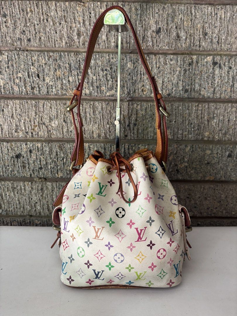 Louis Vuitton Multicolor Bucket Bag (Category: Luxury Bags & Wallets) located in Alcala. Submitted by dela.sole (Listing ID 1438507744, Image 1). Description: - Authentic Louis Vuitton Multicolor Bucket Bag - Iconic multicolor monogram on white coated canvas - Drawstring closure - Leather shoulder strap - Two exterior pockets with buckle closures - Made in France.