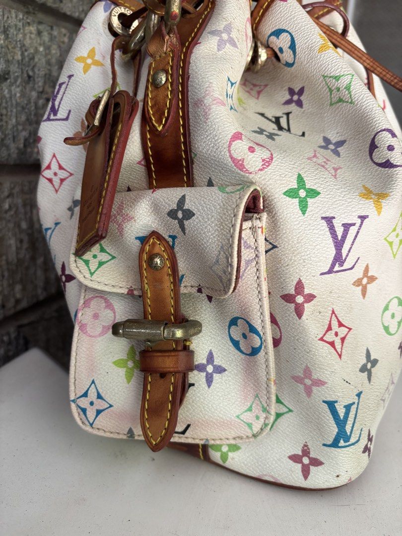 Louis Vuitton Multicolor Bucket Bag (Category: Luxury Bags & Wallets) located in Alcala. Submitted by dela.sole (Listing ID 1438507744, Image 3). Description: - Authentic Louis Vuitton Multicolor Bucket Bag - Iconic multicolor monogram on white coated canvas - Drawstring closure - Leather shoulder strap - Two exterior pockets with buckle closures - Made in France.
