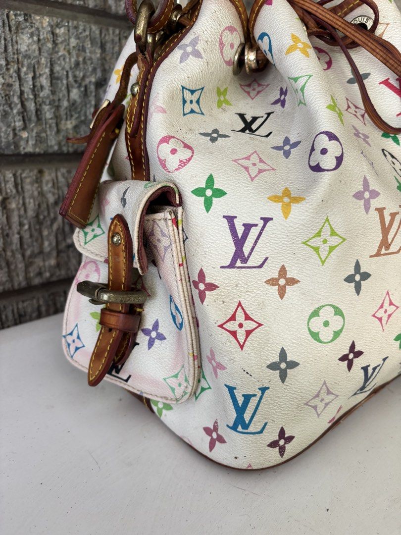 Louis Vuitton Multicolor Bucket Bag (Category: Luxury Bags & Wallets) located in Alcala. Submitted by dela.sole (Listing ID 1438507744, Image 2). Description: - Authentic Louis Vuitton Multicolor Bucket Bag - Iconic multicolor monogram on white coated canvas - Drawstring closure - Leather shoulder strap - Two exterior pockets with buckle closures - Made in France.