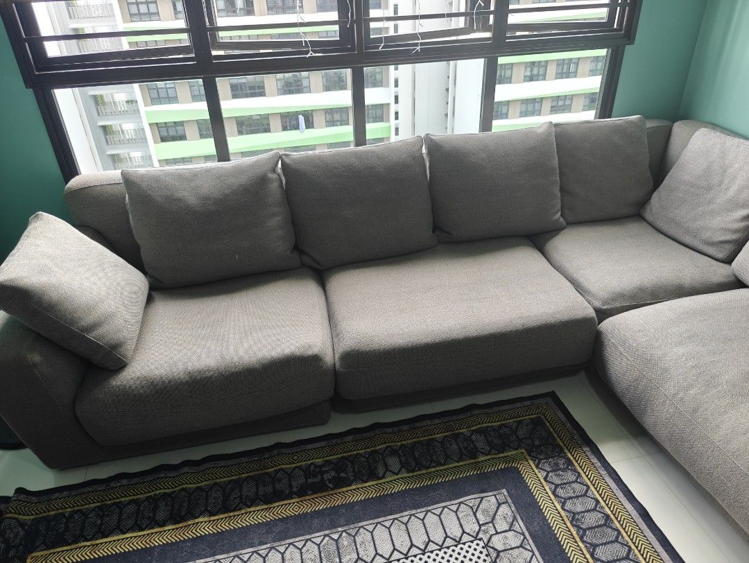 L-Shaped Sofa - Grey (Category: Sofas) located in Singapore. Submitted by rarashenara (Listing ID 1438514442, Image 3). Description: - Comfortable L-shaped sofa - Neutral grey color - Includes cushions - Perfect for lounging and entertaining - Arrange for you own delivery. - Available for collection anytime - Selling due to moving house.