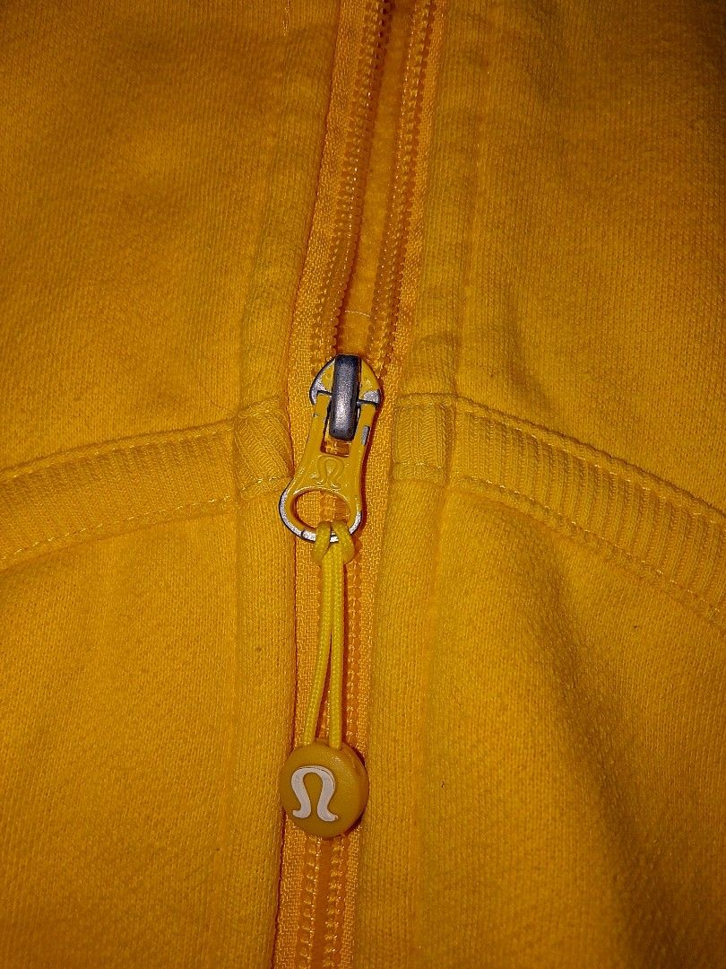 Lululemon Yellow Hoodie Jacket Size 8 (Category: Coats, Jackets and Outerwear) located in Bacoor. Submitted by luckyjohnsel (Listing ID 1438671566, Image 3). Description: - Lululemon hoodie in vibrant yellow - Size 8 - Full zip closure - Hood with Lululemon logo - Pockets - Thumb holes - Soft, comfortable fabric - Lululemon logo on zipper pull.