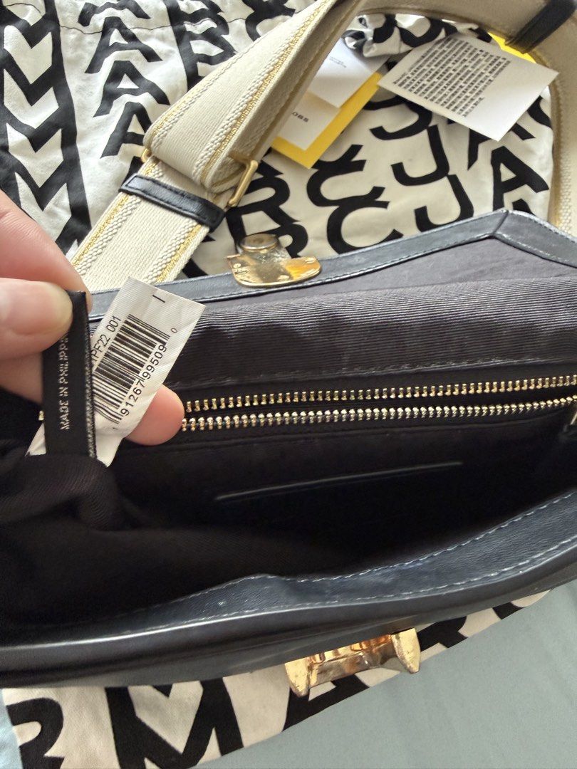 Marc Jacobs The J Marc Shoulder Bag (Category: Luxury Bags & Wallets) located in Manila. Submitted by vetyy1229 (Listing ID 1438505530, Image 3). Description: Authentic Marc Jacobs shoulder bag. Features a black leather exterior with a gold-tone chain strap and a matching adjustable strap. Includes a dust bag and tags. The interior has a zippered pocket and a Marc Jacobs logo patch. Made in the Philippines..
