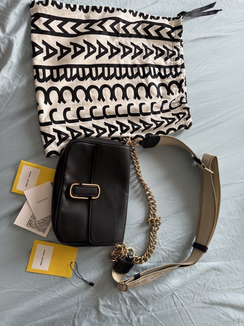 Marc Jacobs The J Marc Shoulder Bag (Category: Luxury Bags & Wallets) located in Manila. Submitted by vetyy1229 (Listing ID 1438505530, Image 2). Description: Authentic Marc Jacobs shoulder bag. Features a black leather exterior with a gold-tone chain strap and a matching adjustable strap. Includes a dust bag and tags. The interior has a zippered pocket and a Marc Jacobs logo patch. Made in the Philippines..