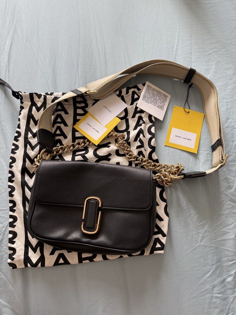 Marc Jacobs The J Marc Shoulder Bag (Category: Luxury Bags & Wallets) located in Manila. Submitted by vetyy1229 (Listing ID 1438505530, Image 1). Description: Authentic Marc Jacobs shoulder bag. Features a black leather exterior with a gold-tone chain strap and a matching adjustable strap. Includes a dust bag and tags. The interior has a zippered pocket and a Marc Jacobs logo patch. Made in the Philippines..