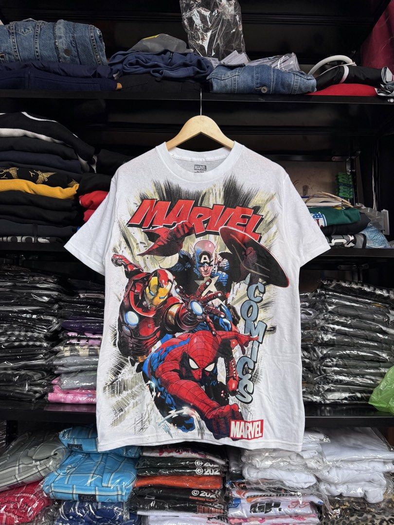 Marvel Comics T-shirt - Medium (Category: Tshirts & Polo Shirts ) located in Pasig City. Submitted by dripthrift1600 (Listing ID 1438533216, Image 1). Description: - Marvel Comics t-shirt - Features Iron Man, Captain America, and Spider-Man - Size: Medium - Dimes: 20x29 - Material: 100% Cotton - Made in Mexico - Brand: C-Life Group Ltd..
