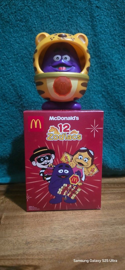 McDonald's Zodiac Toy "TIGER" (Category: Character Goods) located in Calamba. Submitted by decantanddeclutter (Listing ID 1438503832, Image 1). Description: BRAND NEW McDonald's Zodiac toy -Year of the Tiger - Features Grimace inside a TIGER costume - Comes with the original box .