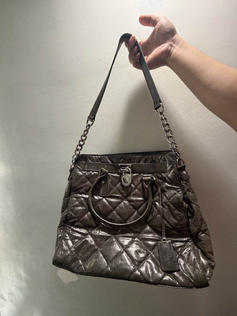 Michael Kors Hamilton Quilted Tote Bag (Category: Luxury Bags & Wallets) located in Tanza. Submitted by iamdhana (Listing ID 1438559771, Image 1). Description: Not rush, will take time if not for my asking price Slightly negotiable Pre-loved - Michael Kors tote bag - Quilted design - Top handle and chain strap - Lock closure plus key - Includes tag - Diamond pattern with metallic finish - Medium size - Ideal for everyday use.