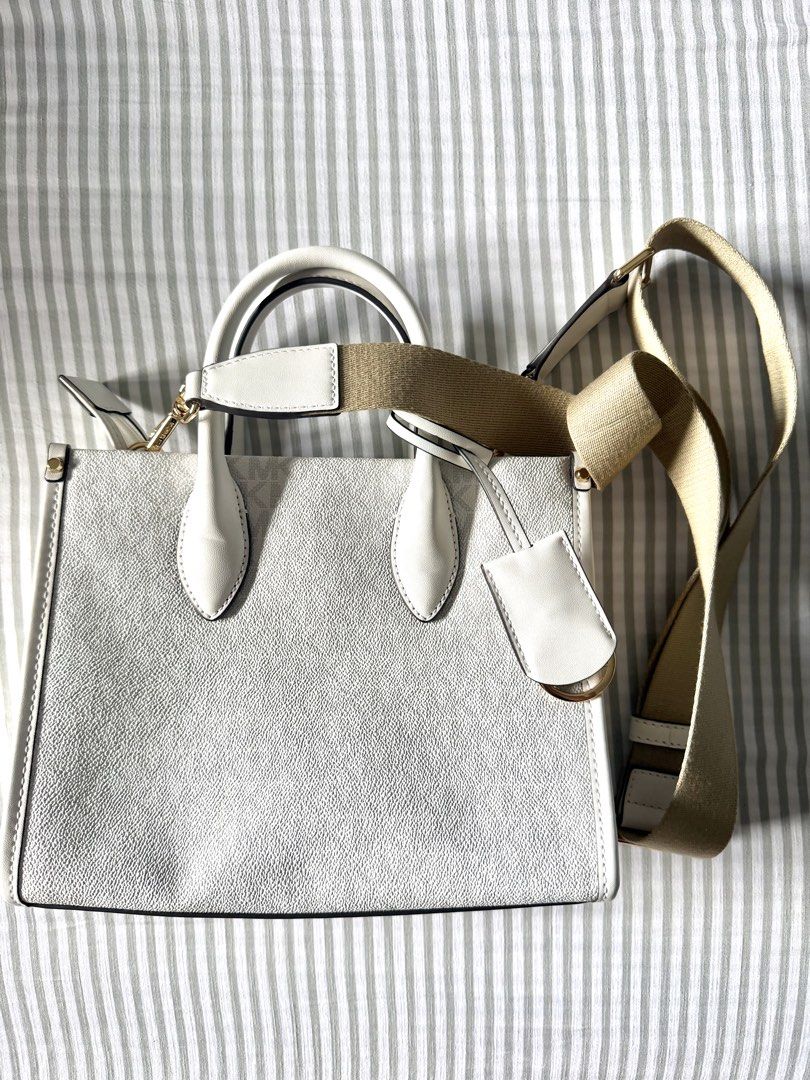 Orig Michael Kors Tote Bag (Category: Luxury Bags & Wallets) located in Mandaluyong City. Submitted by anditime (Listing ID 1438560869, Image 3). Description: White Michael Kors tote bag with shoulder strap ‼️ Needs cleaning, has some denim stains (please see pics).