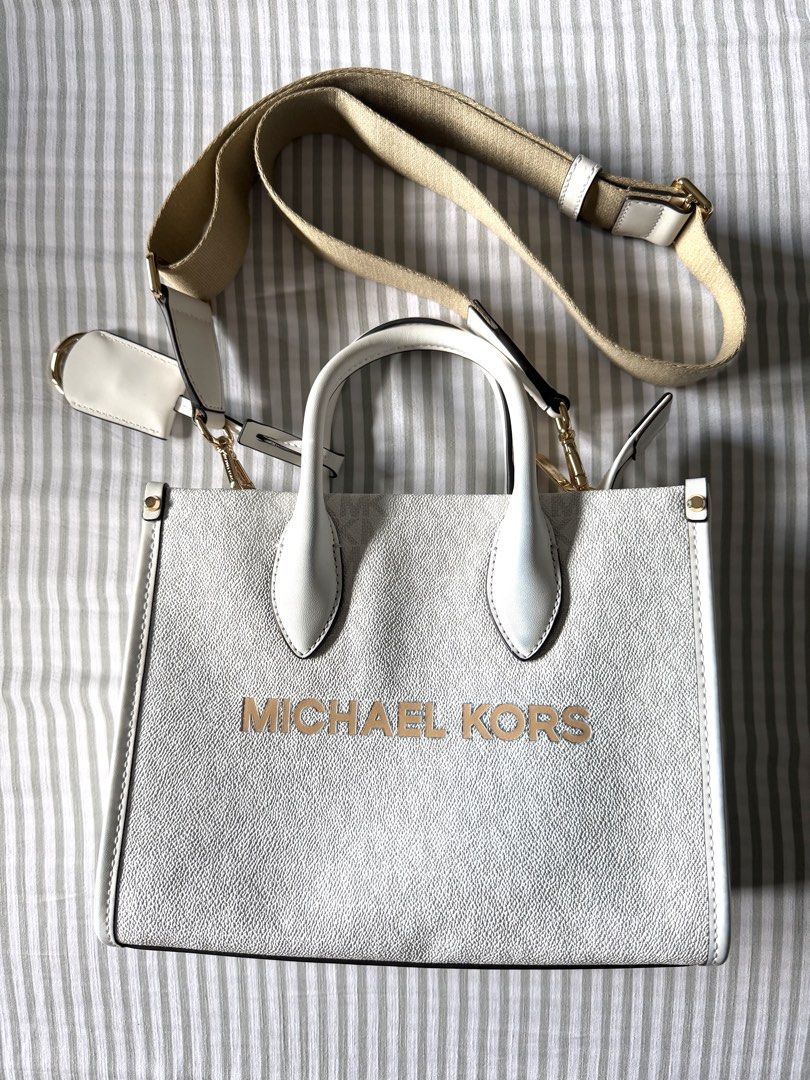 Orig Michael Kors Tote Bag (Category: Luxury Bags & Wallets) located in Mandaluyong City. Submitted by anditime (Listing ID 1438560869, Image 1). Description: White Michael Kors tote bag with shoulder strap ‼️ Needs cleaning, has some denim stains (please see pics).