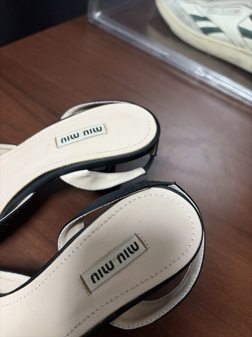 Miu Miu Embellished Slingback Heels (Category: Heels) located in Davao. Submitted by benjhmaquiran (Listing ID 1438618469, Image 2). Description: - Miu Miu slingback heels - Size 36 - Pointed toe design - All-over embellishments - Bow detail - Miu Miu logo on insole - Made in Italy.