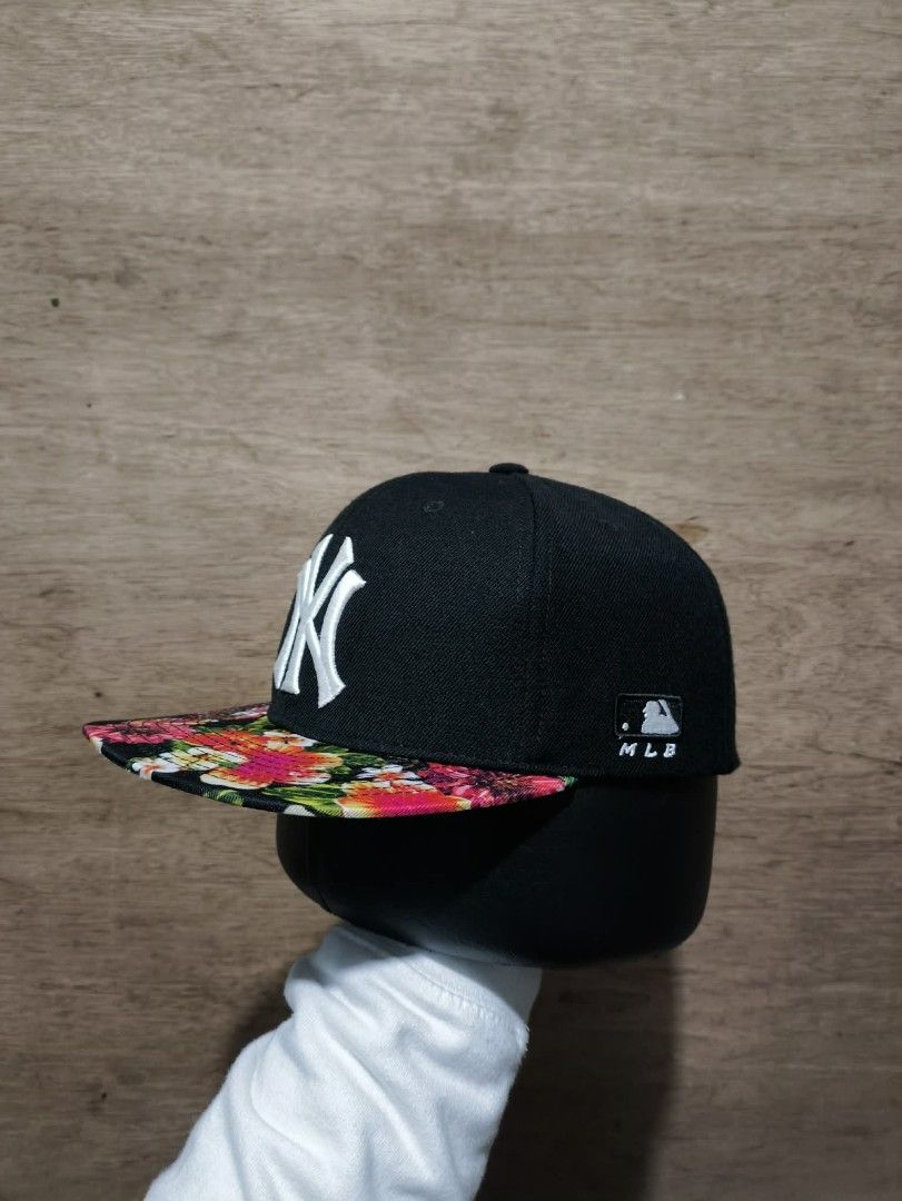 MLB New York Yankees Floral Cap (Category: Caps & Hats) located in Maitum. Submitted by julius0211 (Listing ID 1438596833, Image 1). Description: - New York Yankees cap - Black crown - Floral print brim - MLB logo on the side - "Major League Baseball" and "MANDOOZE CAP HUNANIAN" print at the back.