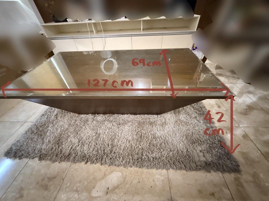 Modern style coffee table (Category: Tables & Sets) located in Manila. Submitted by jamecy (Listing ID 1438621828, Image 2). Description: For sale!! Modern brown wood coffee table with large glass top surface and diamond shaped base Dimensions: 42cm height 127cm width 69cm length.