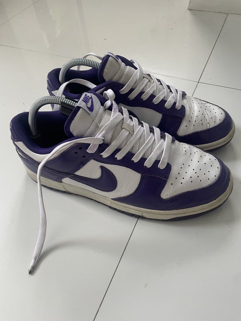 Nike Dunk Low Purple White (Category: Sneakers) located in Taytay. Submitted by deathscythe93 (Listing ID 1438693348, Image 3). Description: Size 9 USM - 27.5CM Nike Dunk Low in a purple and white colorway. Features a leather upper with a white base and purple overlays. The Nike swoosh is visible on the sides. The soles show some wear. The laces are white..