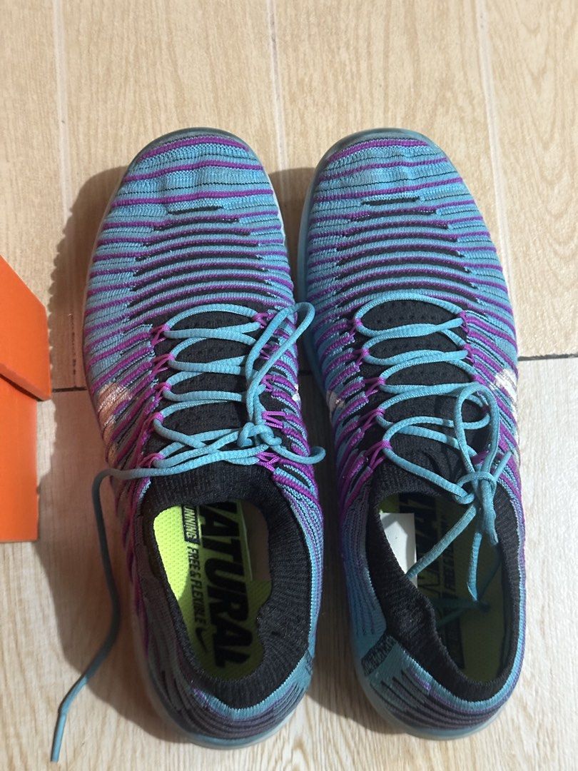 Nike Free RN Motion Flyknit Women's Sneakers (Category: Sneakers) located in Paranaque City. Submitted by thriftclothing101 (Listing ID 1438590954, Image 2). Description: - Nike Free RN Motion Flyknit sneakers - Color: Blue and Purple - Size: US 8 - Features: - Flyknit upper - Flexible sole - Sock-like collar - Lace-up closure - Includes original box - Nike swoosh logo visible.