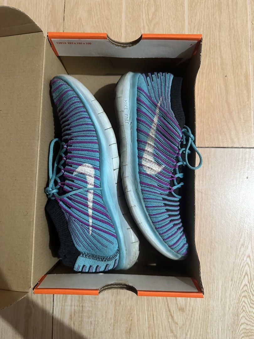 Nike Free RN Motion Flyknit Women's Sneakers (Category: Sneakers) located in Paranaque City. Submitted by thriftclothing101 (Listing ID 1438590954, Image 3). Description: - Nike Free RN Motion Flyknit sneakers - Color: Blue and Purple - Size: US 8 - Features: - Flyknit upper - Flexible sole - Sock-like collar - Lace-up closure - Includes original box - Nike swoosh logo visible.