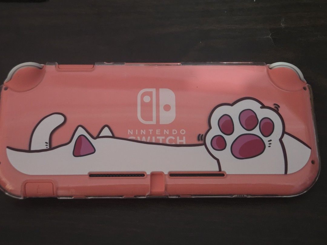 Nintendo Switch Lite Coral with Cat Case (Category: Nintendo) located in Manila. Submitted by clodmnyu (Listing ID 1438576725, Image 3). Description: - Coral Nintendo Switch Lite console - Includes a cute cat-themed case - Case features paw prints and cat design - Package includes console and case.